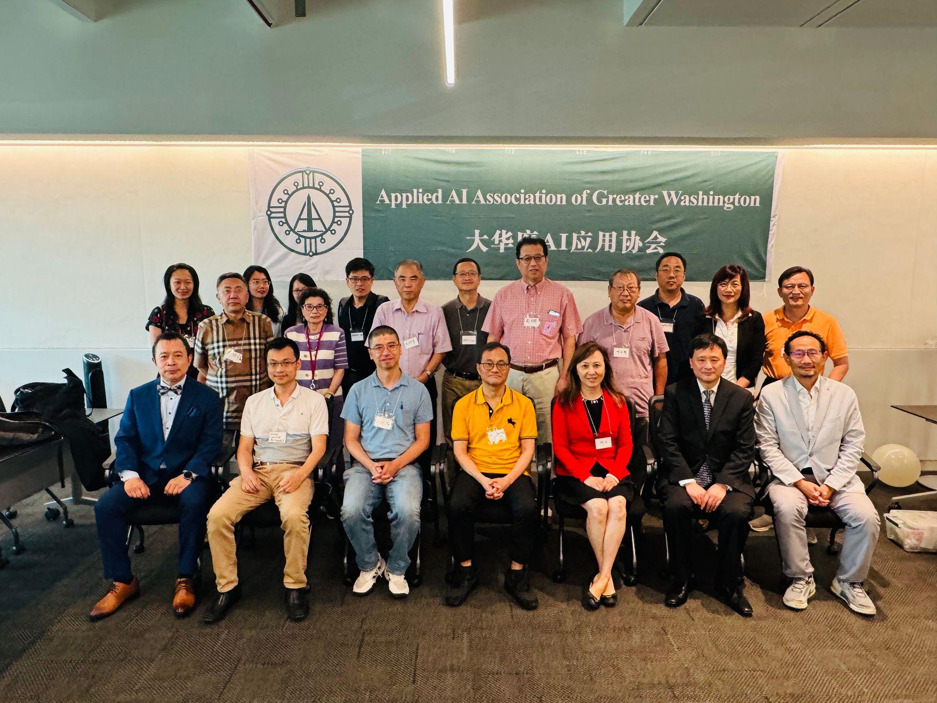 Group of people posing in front of a banner for the Applied AI Association of Greater Washington.